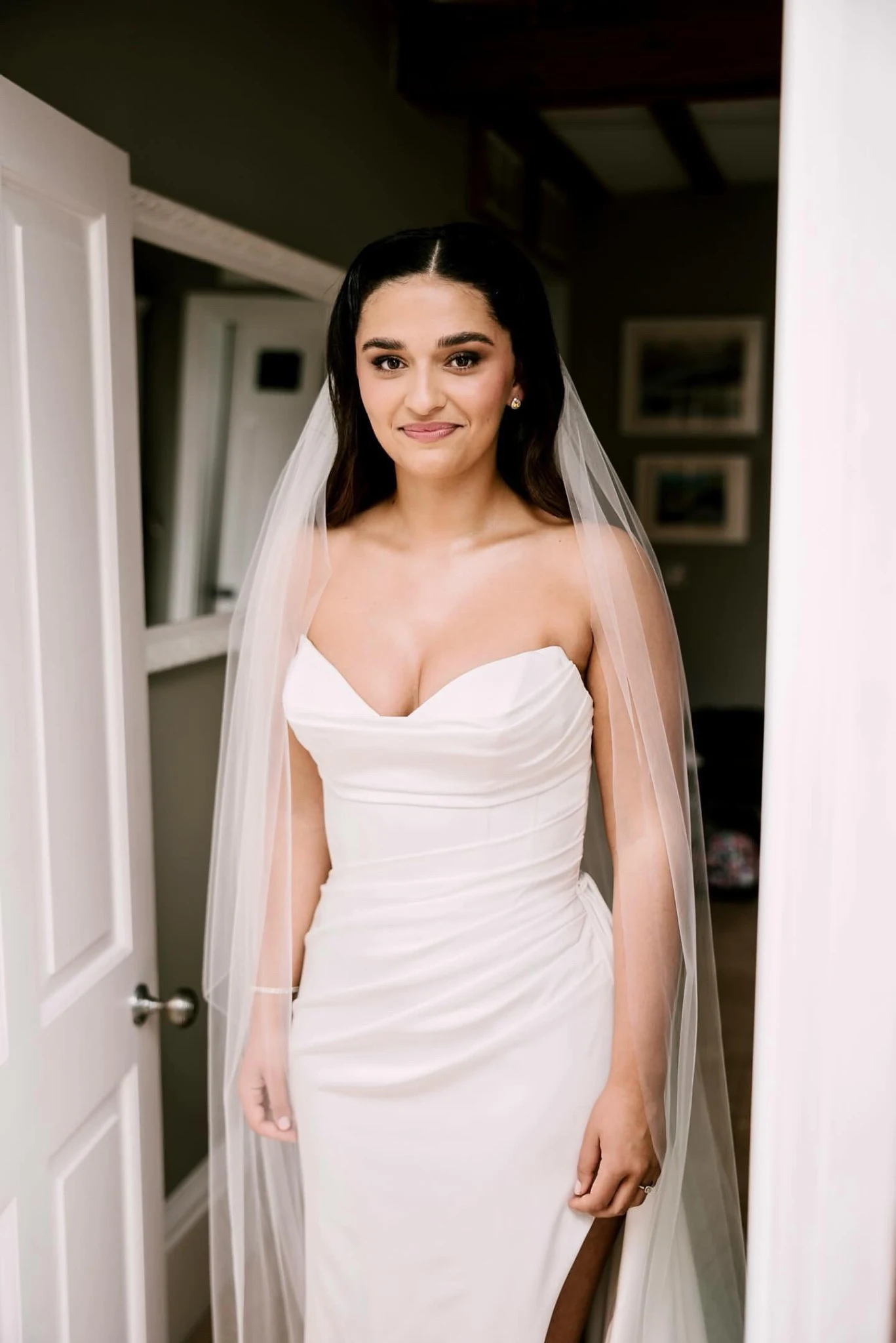 Olivia bridal hair at Riverlands Wedding Barns — the bride in a doorway before the ceremony.