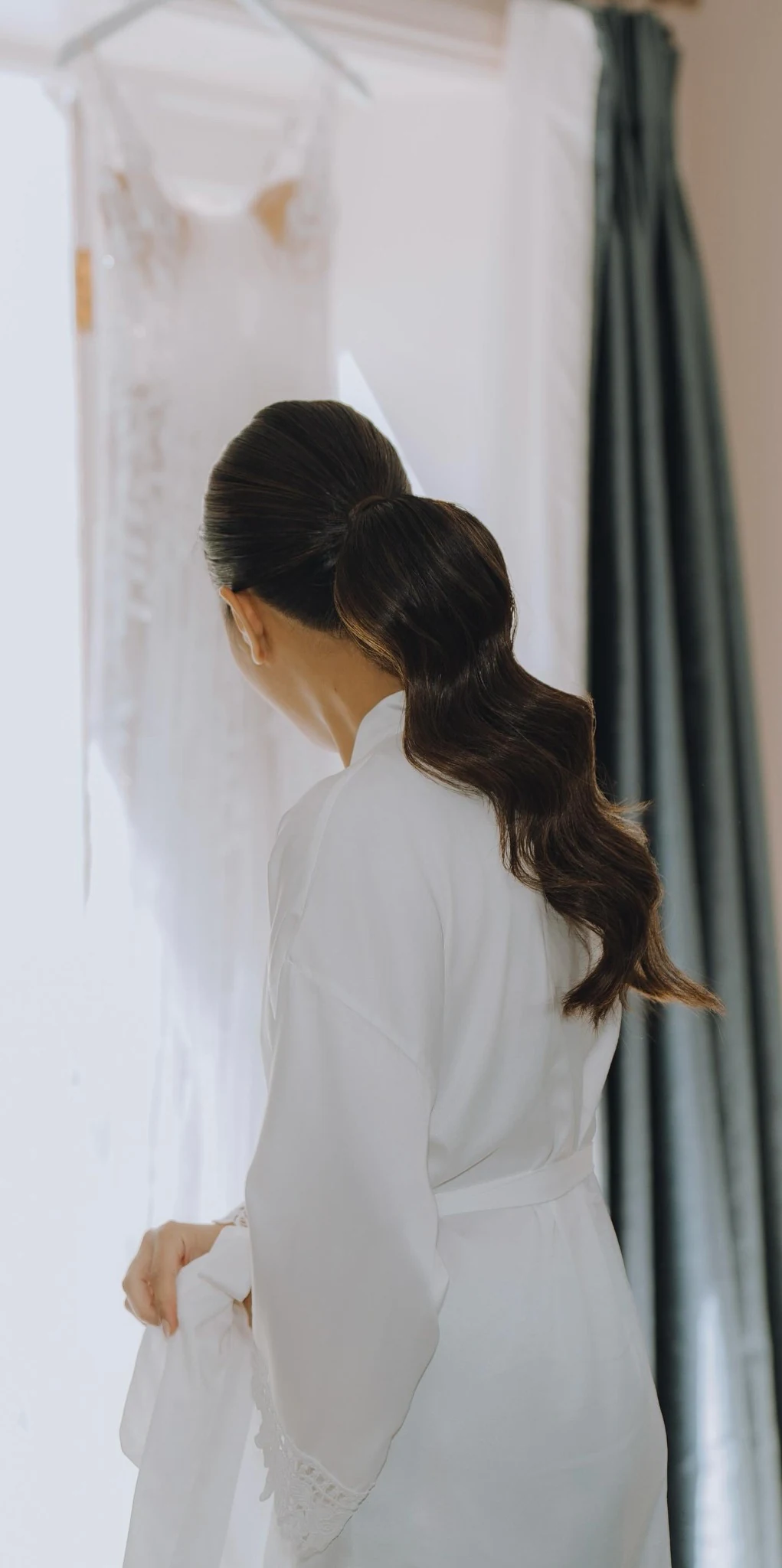 Loi & Tom bridal hair at Beverley Barn — a low bridal ponytail worn with a long veil.