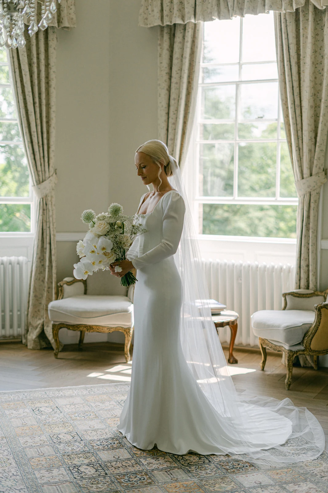 Amy & Sonny bridal hair at Middleton Lodge — the bride at a tall window in her gown.
